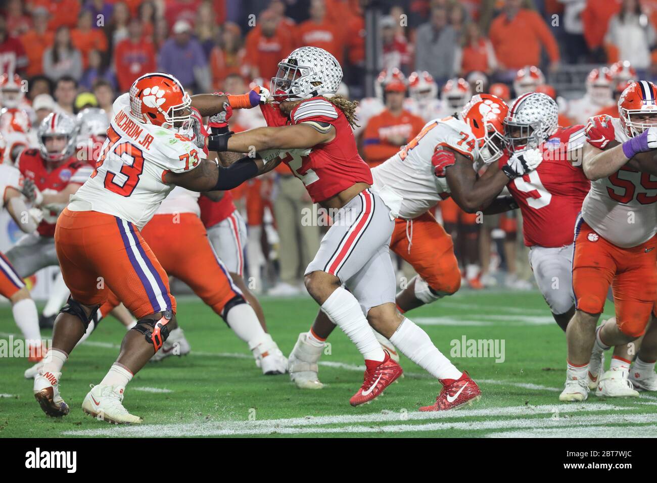 Chase Young (2), Ohio State defensive end, battles Tremayne Anchrum Jr. (73), Clemson offensive lineman, during the 2019 Fiesta Bowl CFP semifinal. Stock Photo