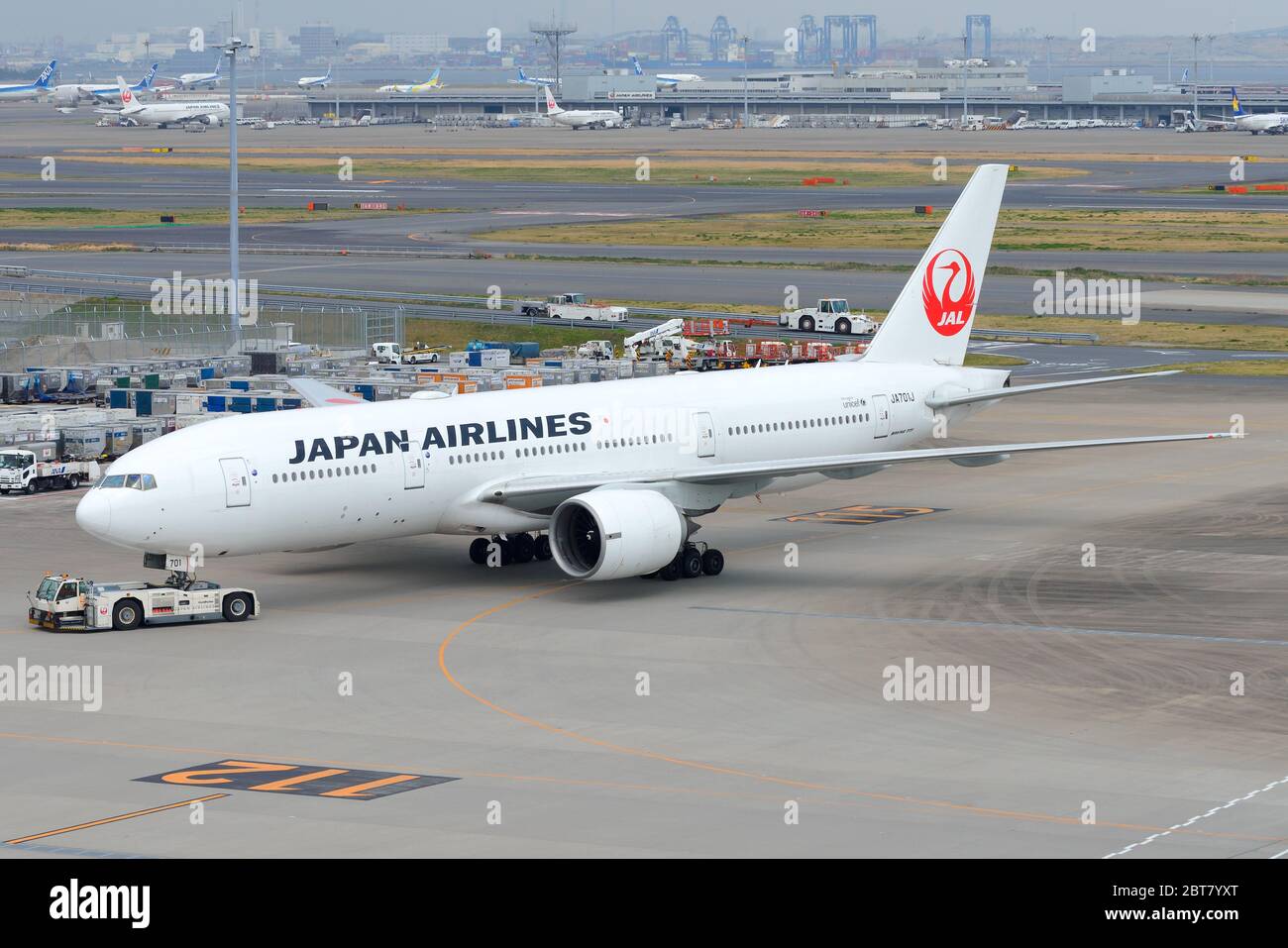 Japan Airlines Boeing 777 JA701J being pushed back at Tokyo Haneda International Airport (HND). Aircraft 777-200 of Japanese airline know as JAL. Stock Photo