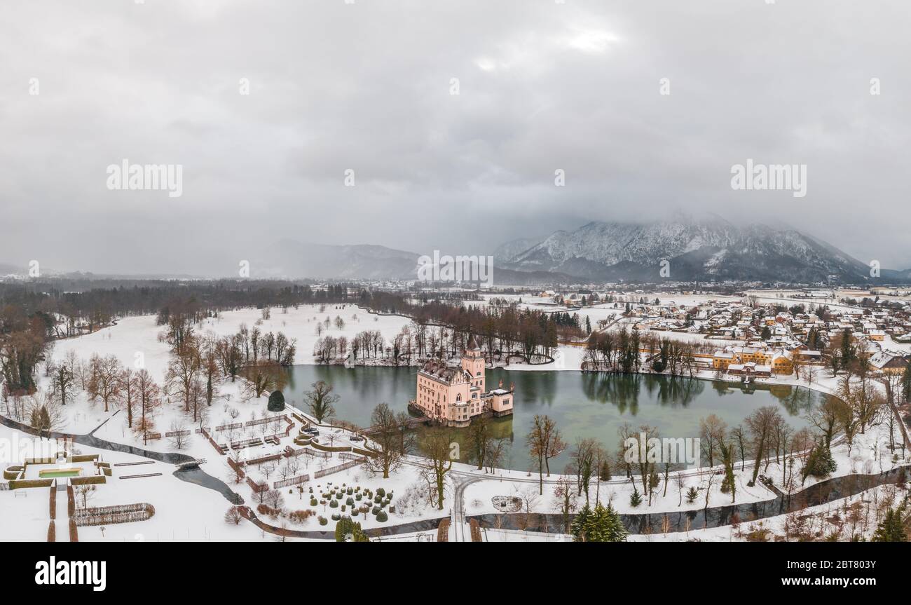 Aerial view of Schloss Anif moated castle in artificial pond Salzburg outskirts in heavy snow view of untersberg Stock Photo