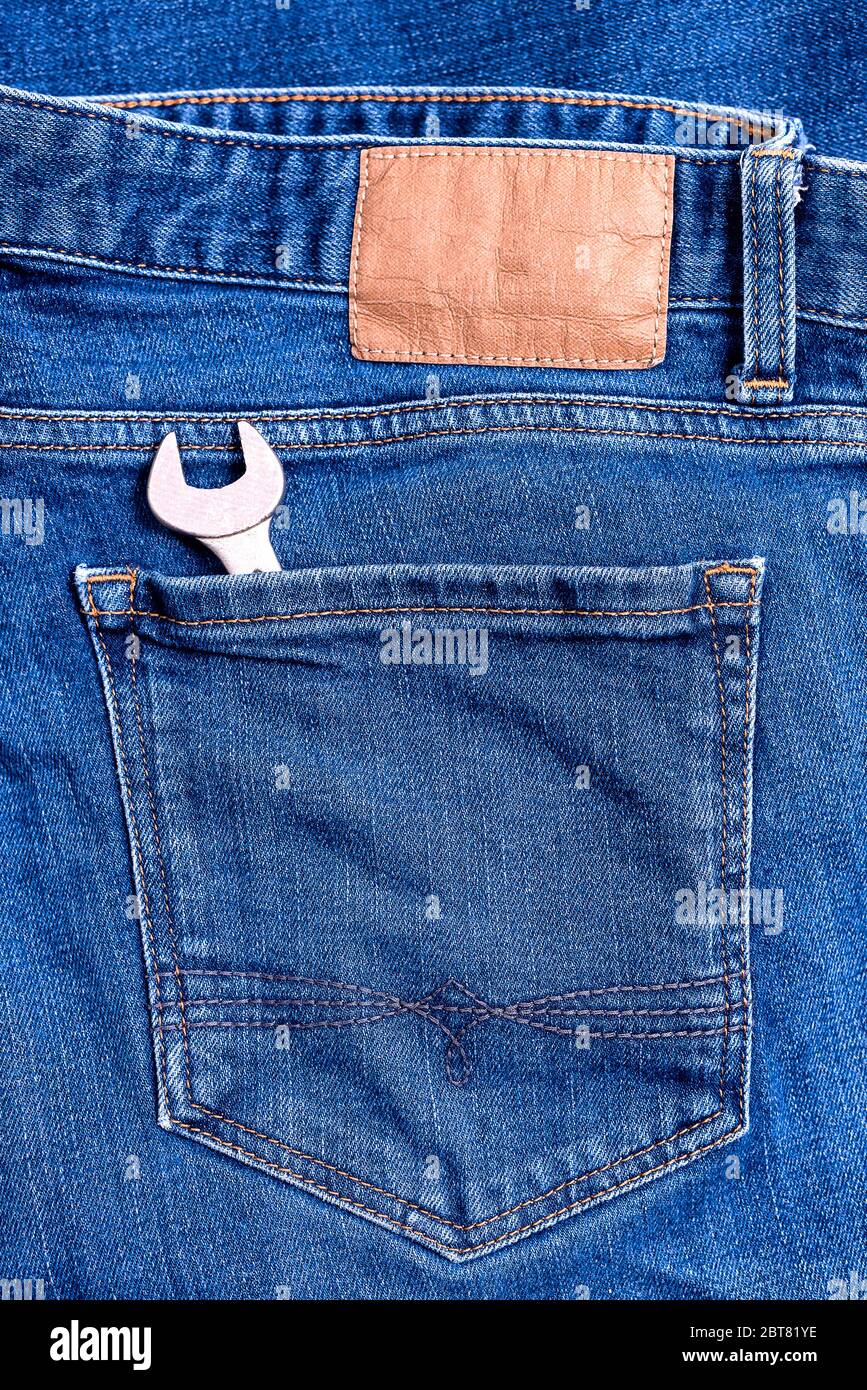 Close up of Jeans back pocket of classic blue denim pants with workman  wrench tool Stock Photo - Alamy