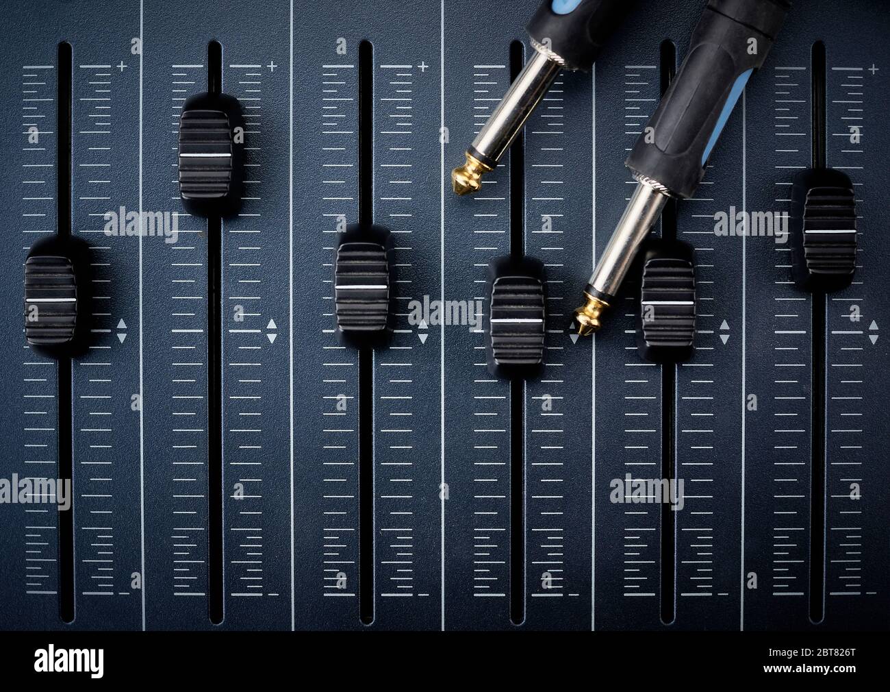 audio cables with jack connectors on faders of a mixer for audio