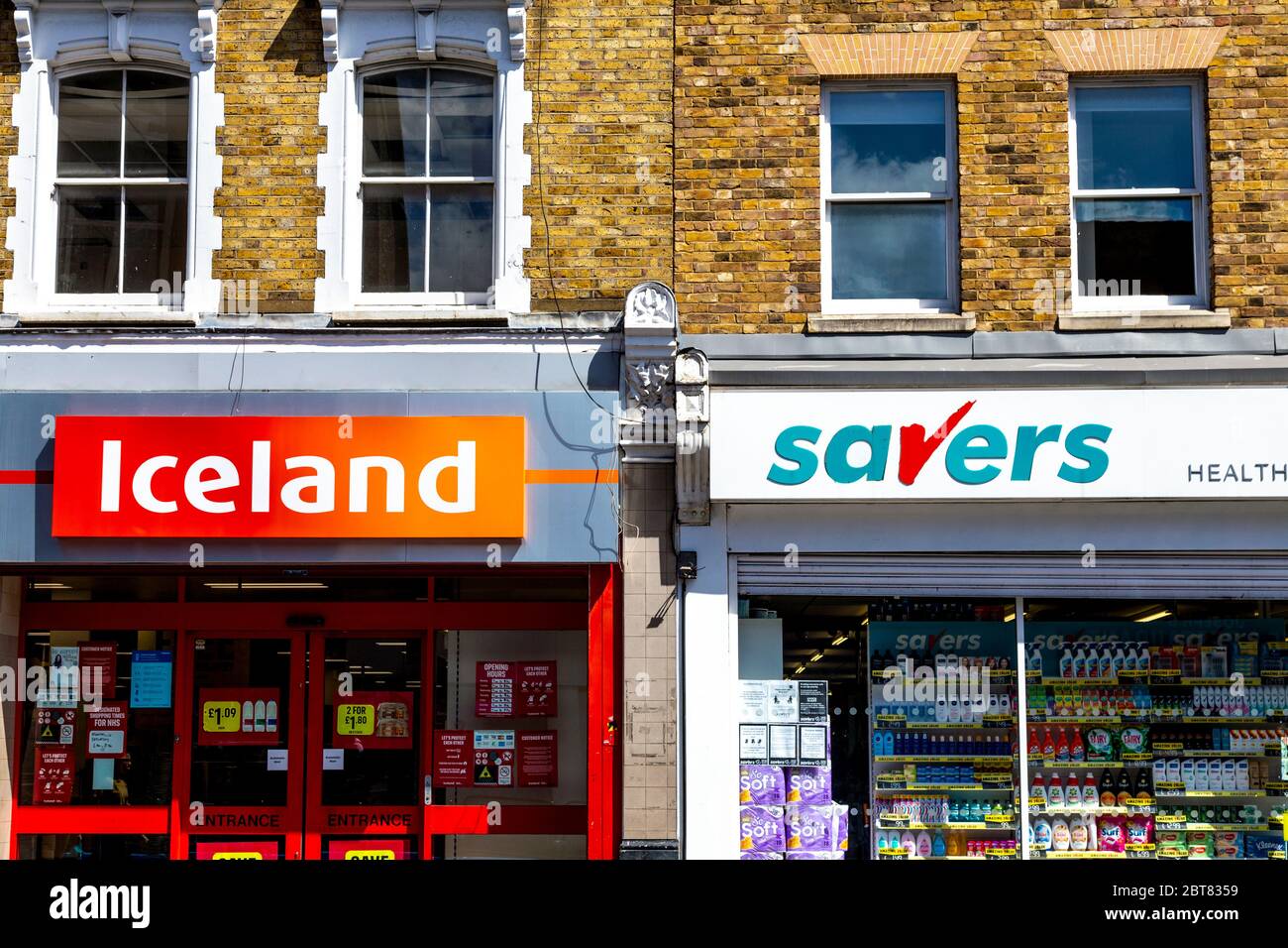Signs for budget supermarket Iceland and discount health and beauty chain Savers, London, UK Stock Photo