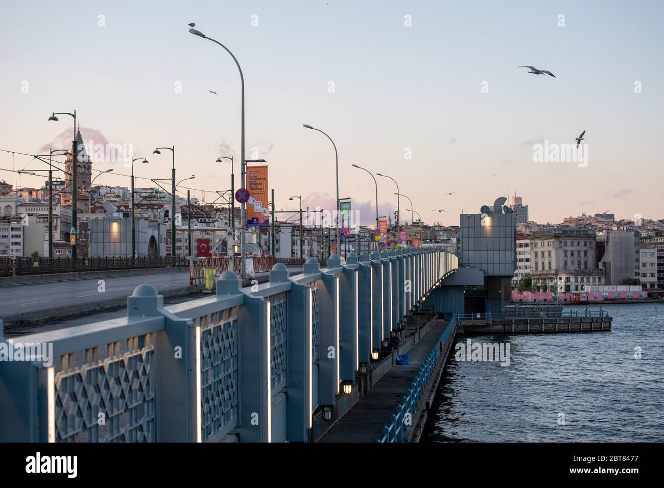 Empty view of the Galata Bridge, is a bridge that spans the Golden Horn, during the curfew on Ramadan. Stock Photo