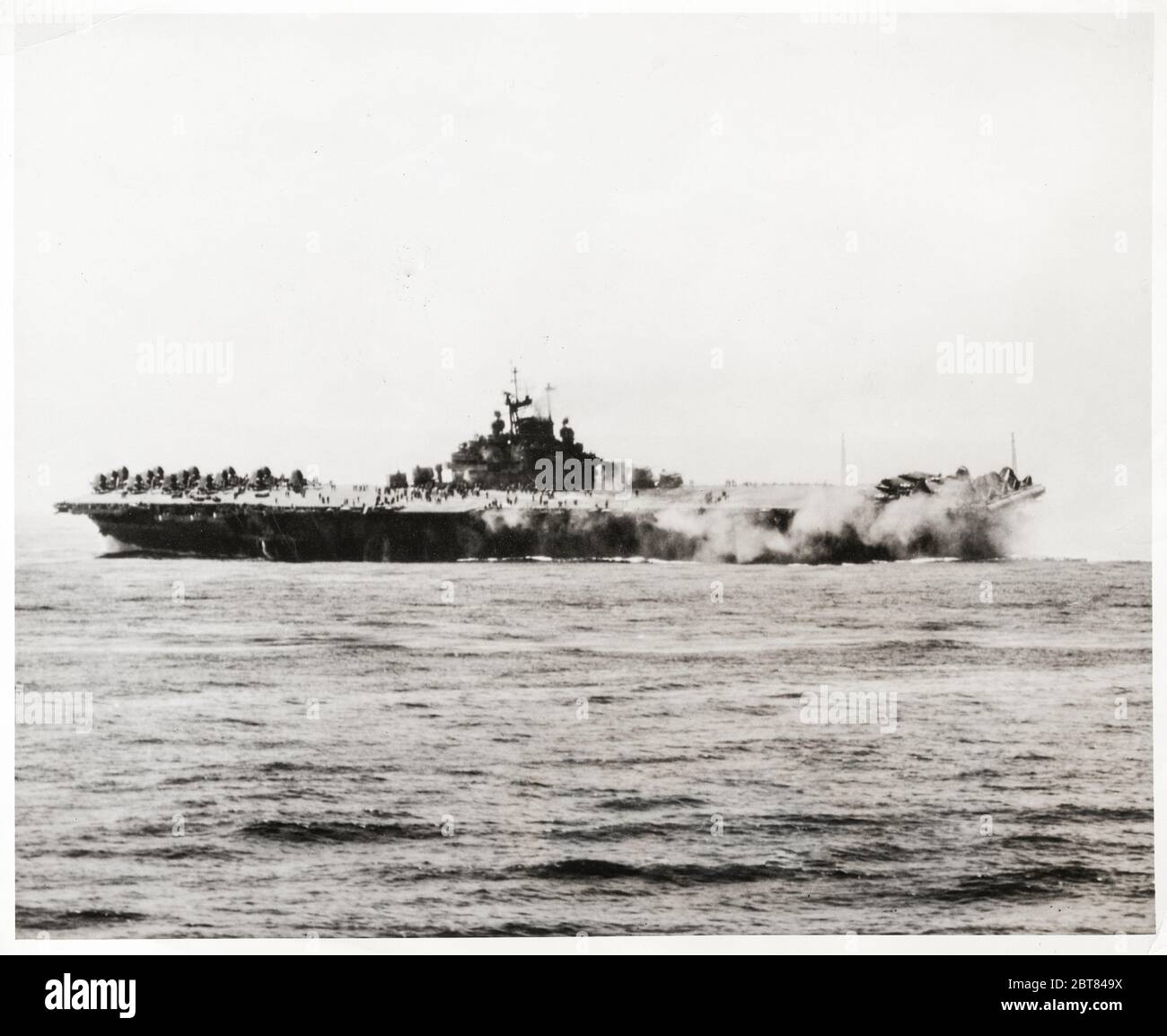 Vintage photograph World War II - US aircraft carrier Intrepid after attack by Japanese suicide kamikaze bomber Stock Photo