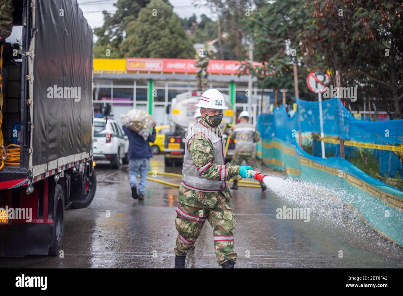 Bogota, Colombia. 23rd May, 2020. Soldiers from the Military Police Battalion during a cleaning, disinfection and spraying session in the La Mariposa Mariposa sector to counter the spread of the corona virus, COVID 19 Credit: Daniel Garzon Herazo/ZUMA Wire/Alamy Live News Stock Photo