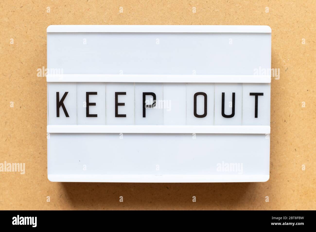 Lightbox with word keep out on wood background Stock Photo