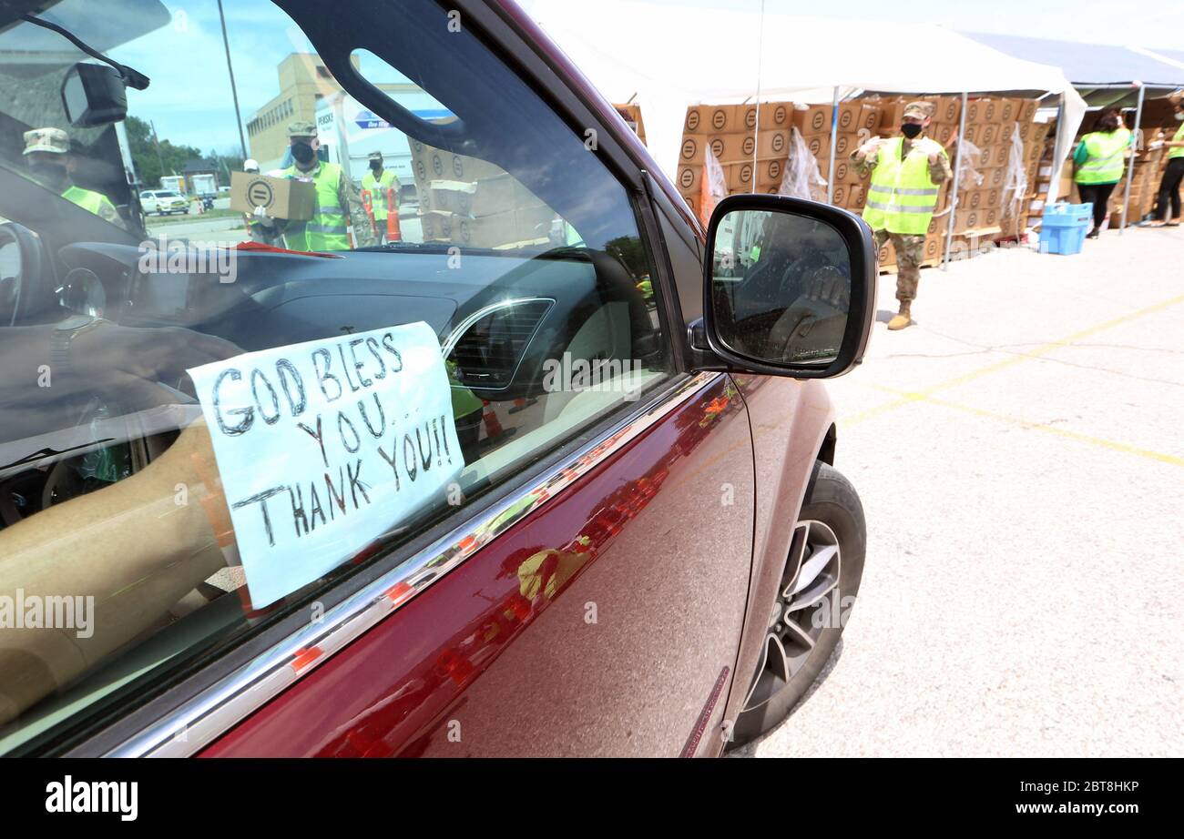 St. Louis, United States. 23rd May, 2020. A car driving up to receive food displays a sign thanking volunteers at the St. Louis Urban League's food give-a-way in St. Louis on Saturday, May 23, 2020. The 3300 cars that will get food will receive enough food to feed a family of four for several days. This event is the eighth food give-a-way put on by the Urban League. Many are in need of the food due to the coronavirus. Photo by Bill Greenblatt/UPI Credit: UPI/Alamy Live News Stock Photo