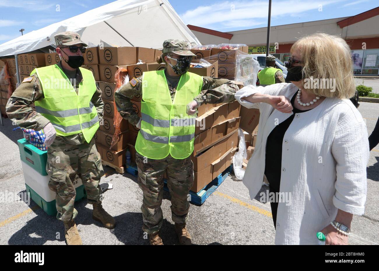 St. Louis, United States. 23rd May, 2020. St. Louis Mayor Lyda Krewson bumps elbows with Missouri National Guard members at the St. Louis Urban League's food give-a-way in St. Louis on Saturday, May 23, 2020. The 3300 cars that will get food will receive enough food to feed a family of four for several days. This event is the eighth food give-a-way put on by the Urban League. Many are in need of the food due to the coronavirus. Photo by Bill Greenblatt/UPI Credit: UPI/Alamy Live News Stock Photo