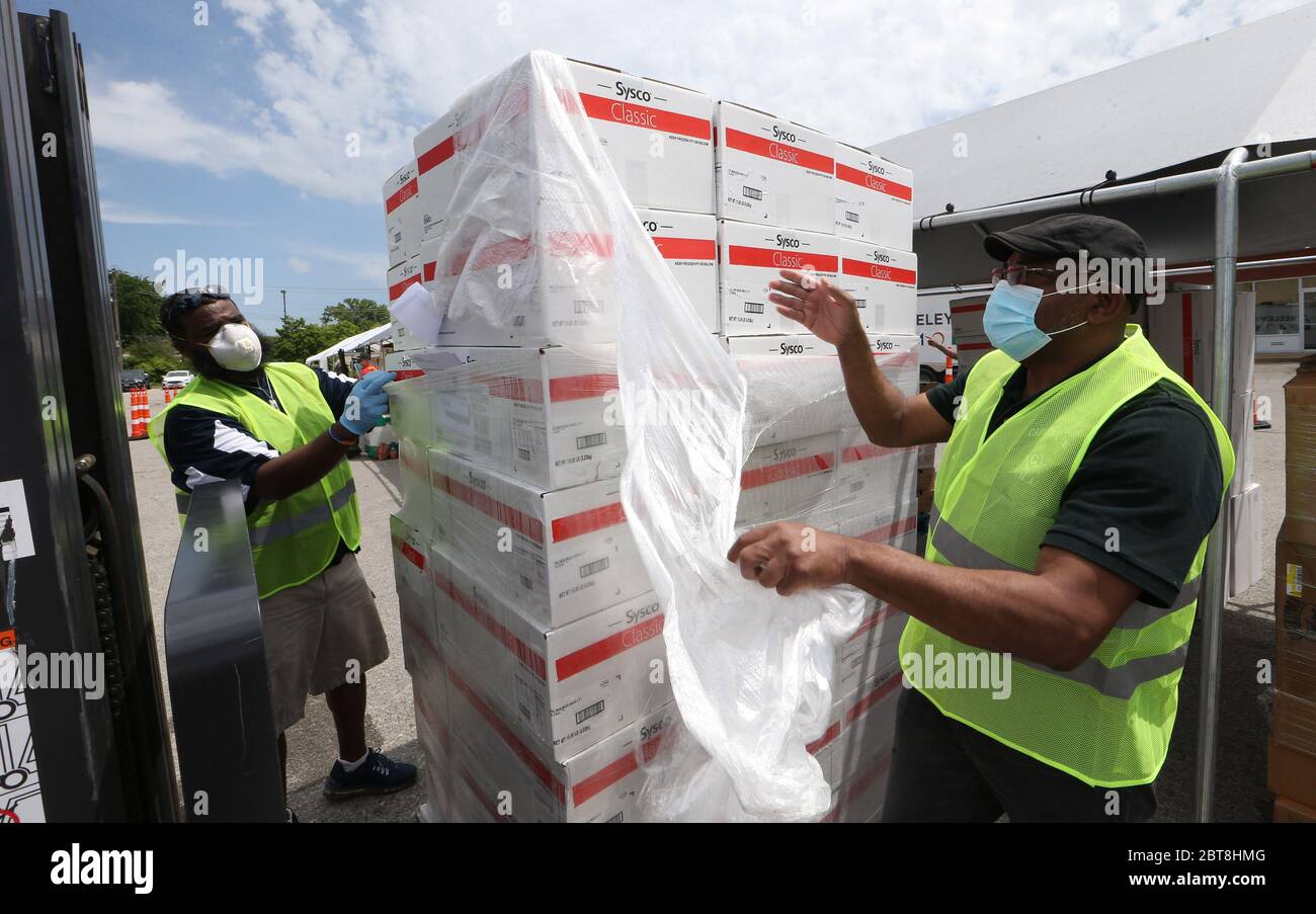 St. Louis, United States. 23rd May, 2020. Volunteers unwrap product to be given away at the St. Louis Urban League's food give-a-way in St. Louis on Saturday, May 23, 2020. The 3300 cars that will get food will receive enough food to feed a family of four for several days. This event is the eighth food give-a-way put on by the Urban League. Many are in need of the food due to the coronavirus. Photo by Bill Greenblatt/UPI Credit: UPI/Alamy Live News Stock Photo