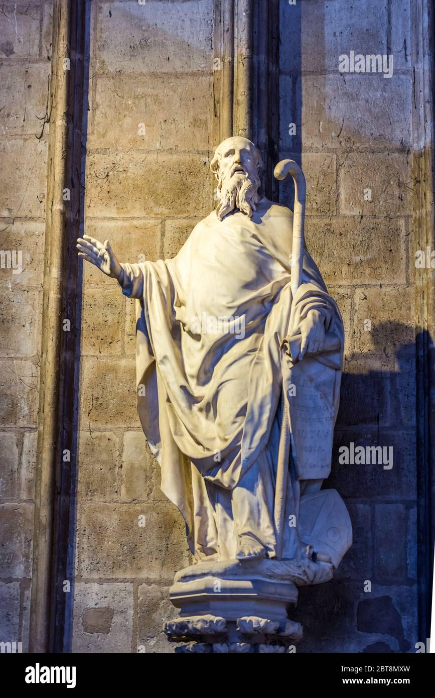 Marble statue of famous person inside of the NotreDame de Paris before