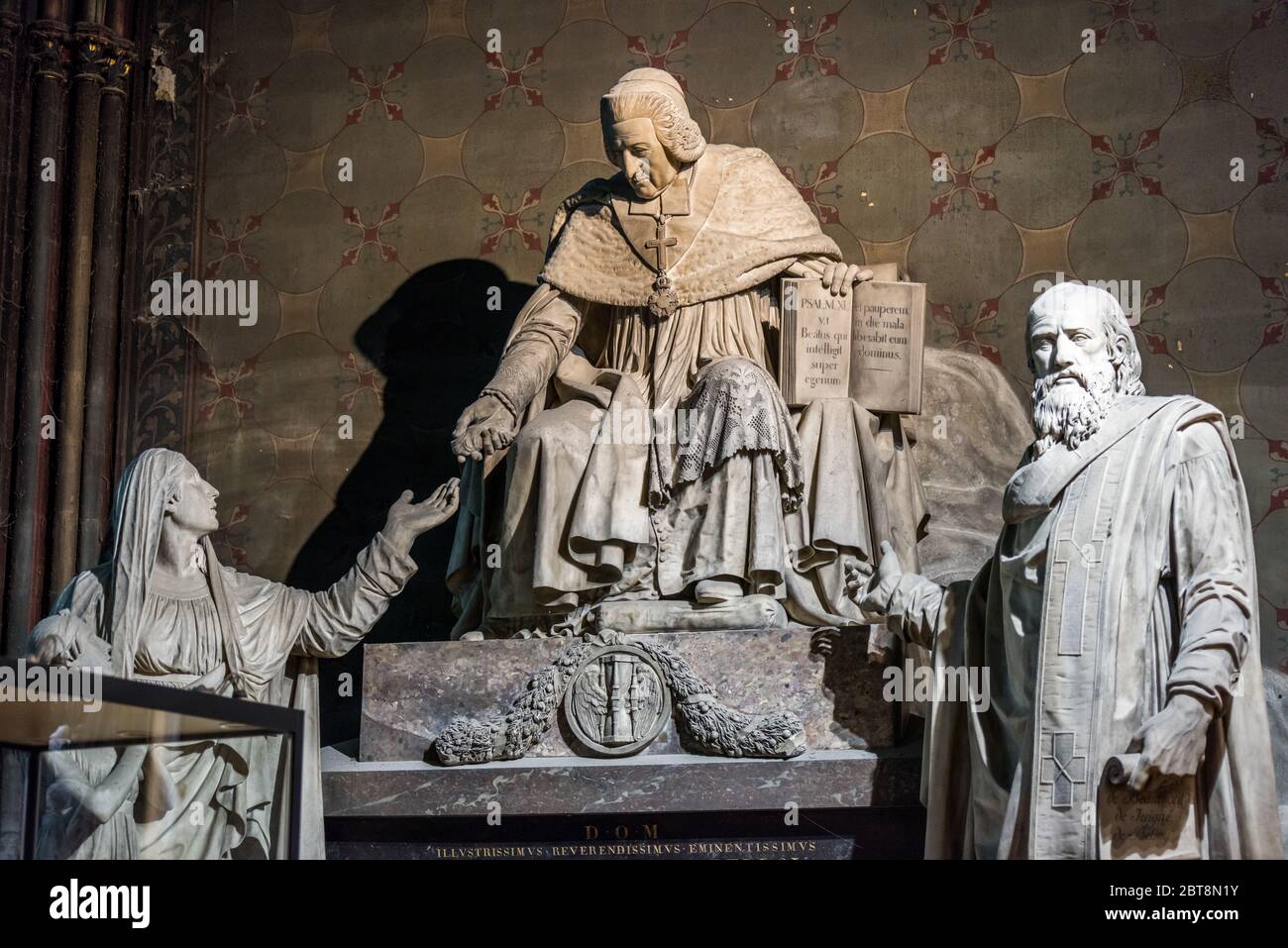 Marble statue of famous person inside of the NotreDame de Paris before