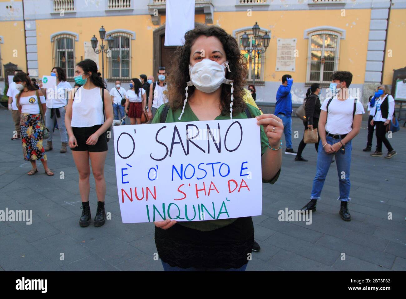 A woman shows her protest cartel to the flash mob organized for the protection of the river Sarno in southern Italy . Stock Photo