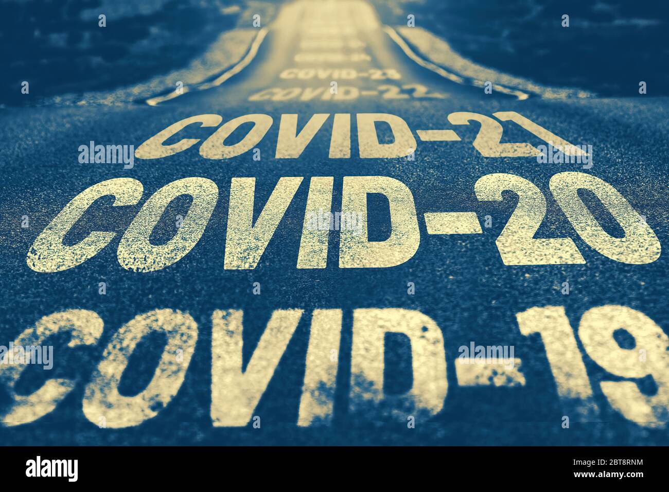 Deserted highway with the text COVID-19, COVID-20, COVID-21 and so on. The concept of new world pandemics. Blue background Stock Photo