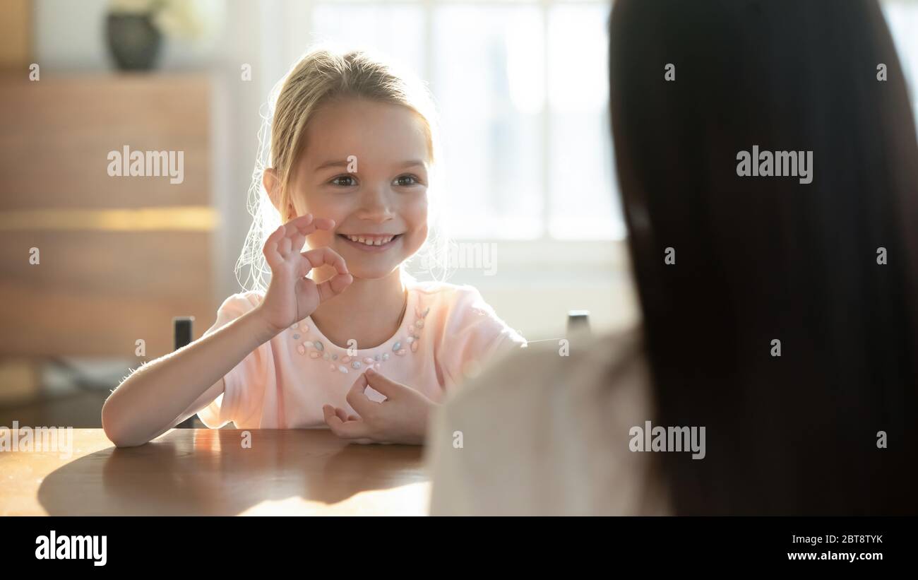 Happy little girl practice sign language with mom Stock Photo