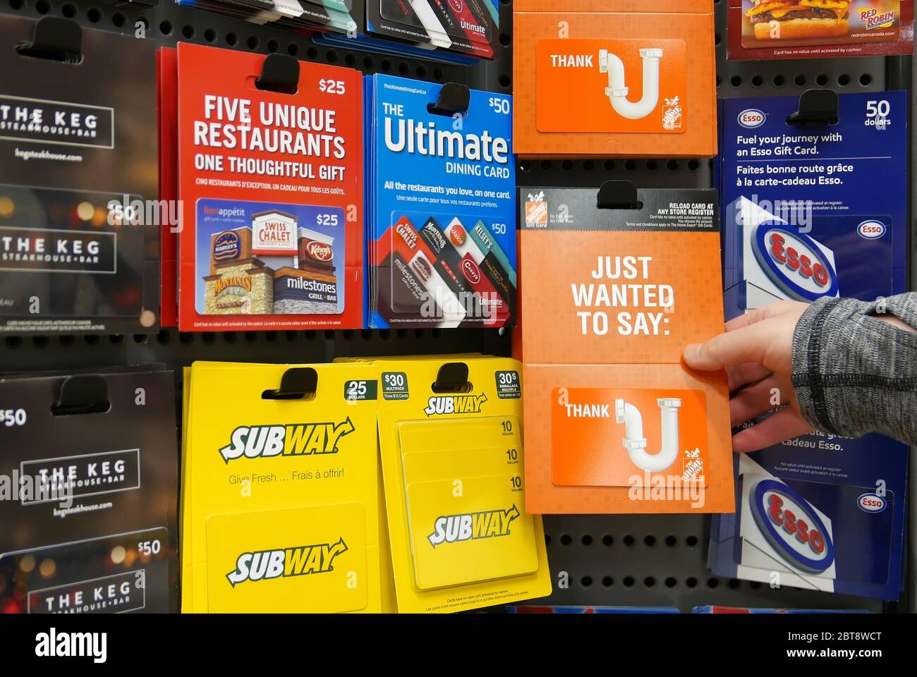 Motion of woman picking home depot gift card Stock Photo