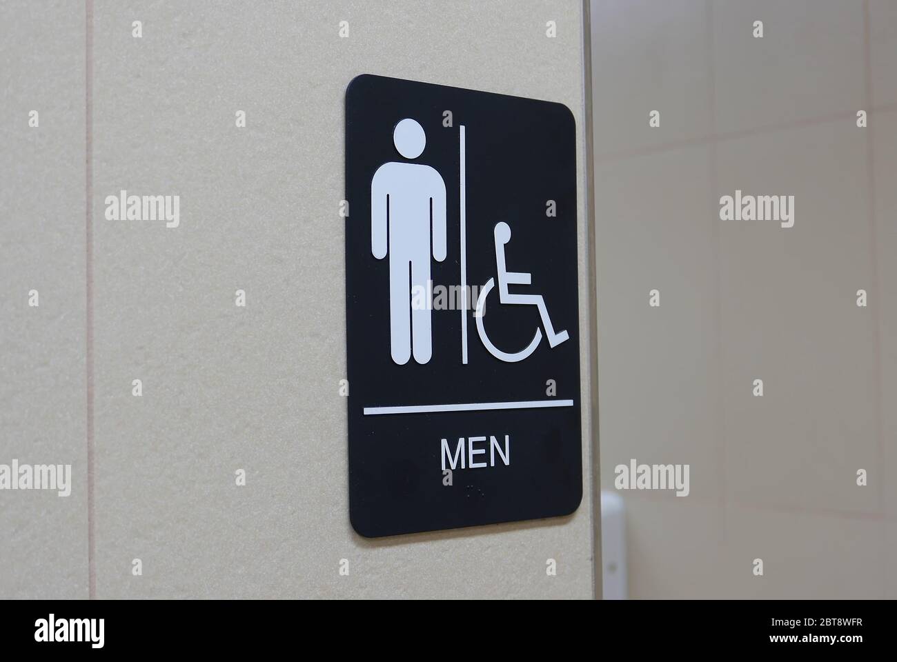 Motion of man and disable washroom logo on wall Stock Photo