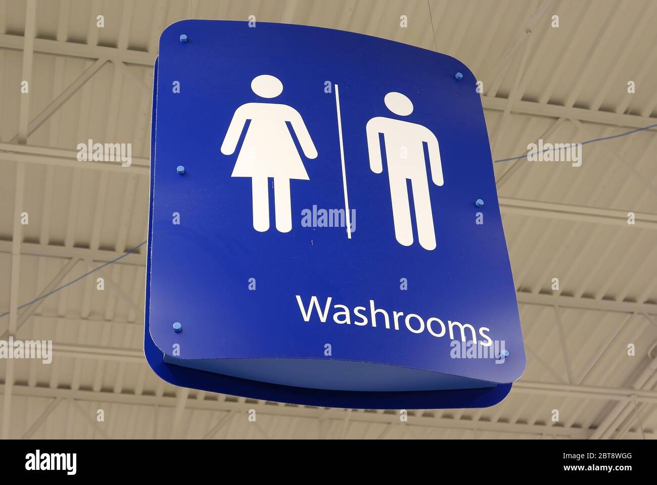 Motion of man and woman washroom logo hanging up the roof Stock Photo