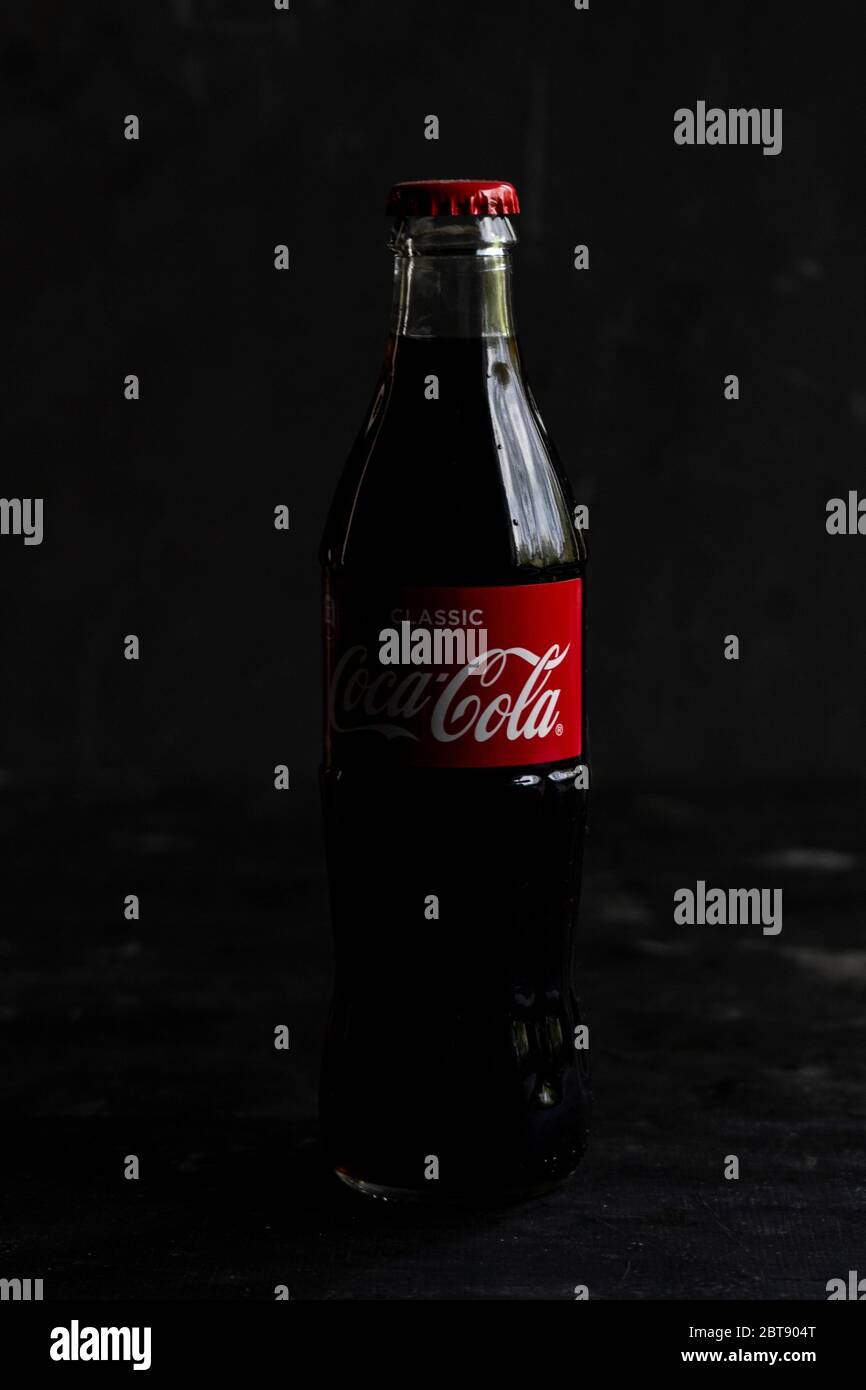 glass bottle of Coca-cola carbonated drink, with a red label on a dark  background Stock Photo - Alamy