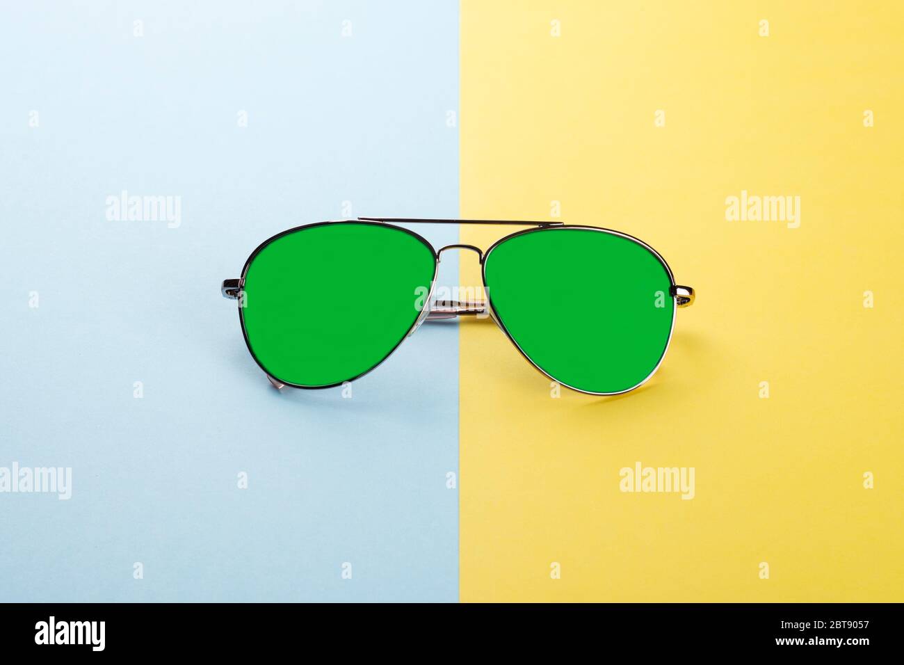 Sunglasses on blue yellow background as concept protect eyes from uv