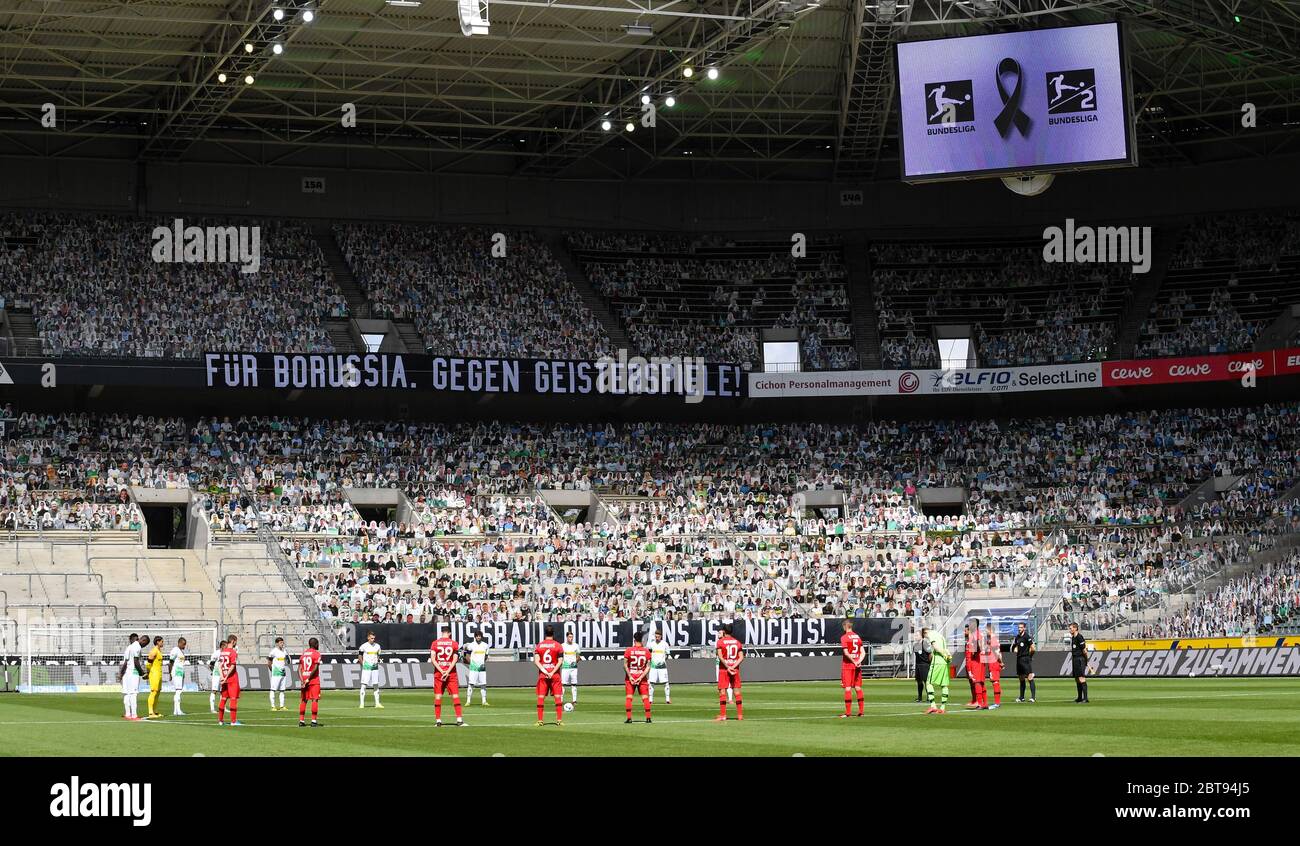 Borussia Park Moenchengladbach Germany, Football: German Bundesliga matchday 27, Borussia Moenchengladbach (BMG, white) vs Bayer 04 Leverkusen (B04, red) 1:3 — Minute of silence in memory of Corona victims. The stands have been filled with photographic portraits of  supporters at their usual stand or seat. Because of the Corona virus pandemic all german league matches are played in empty stadiums without spectators.   Foto: Maik Hölter/team2sportphoto/Pool/via Kolvenbach  Only for editorial use!   DFL regulations prohibit any use of photographs as image sequences and/or quasi-video. Stock Photo