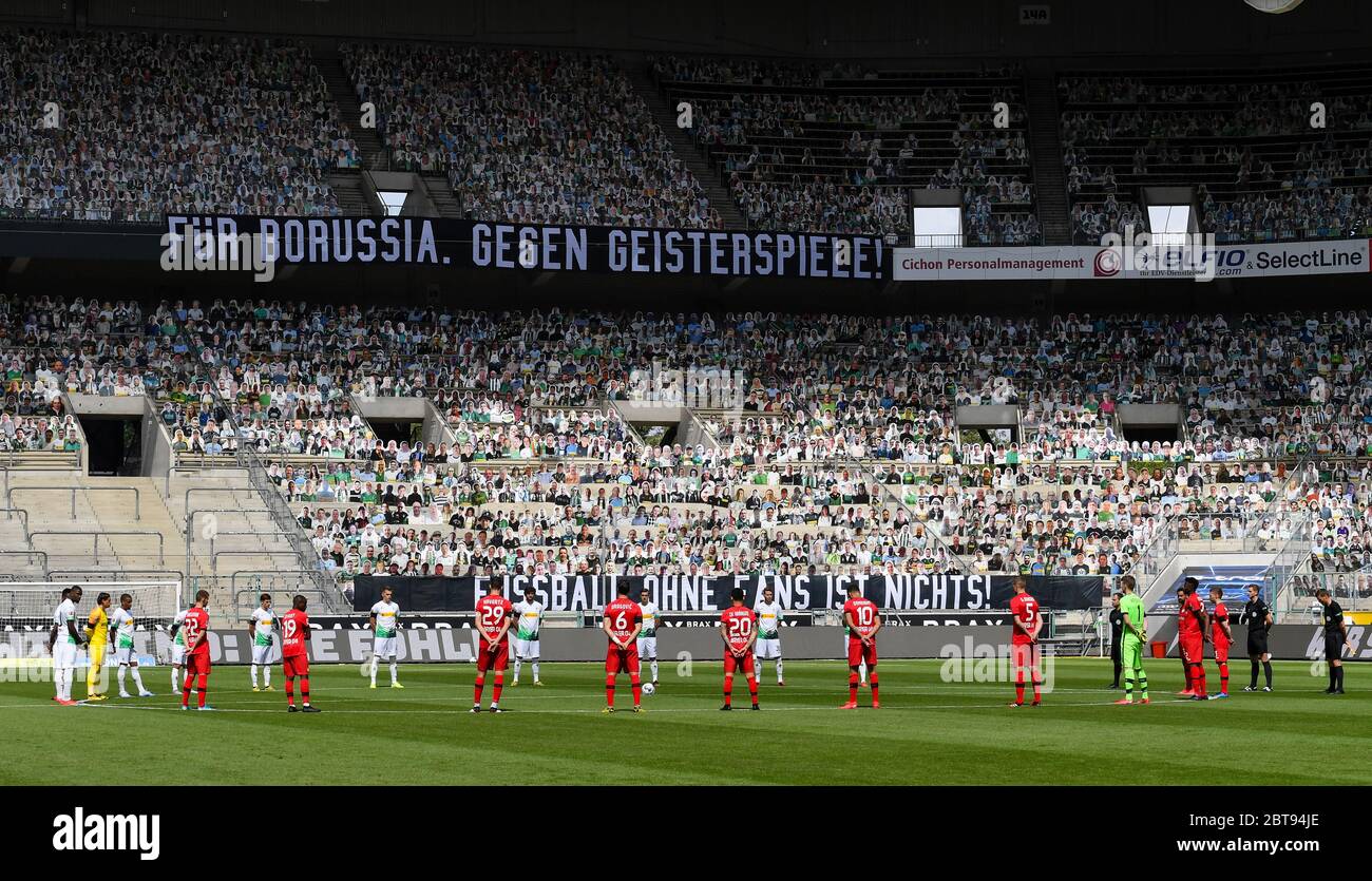 Borussia Park Moenchengladbach Germany, Football: German Bundesliga matchday 27, Borussia Moenchengladbach (BMG, white) vs Bayer 04 Leverkusen (B04, red) 1:3 — Minute of silence in memory of Corona victims. The stands have been filled with photographic portraits of  supporters at their usual stand or seat. Because of the Corona virus pandemic all german league matches are played in empty stadiums without spectators.   Foto: Maik Hölter/team2sportphoto/Pool/via Kolvenbach  Only for editorial use!   DFL regulations prohibit any use of photographs as image sequences and/or quasi-video. Stock Photo