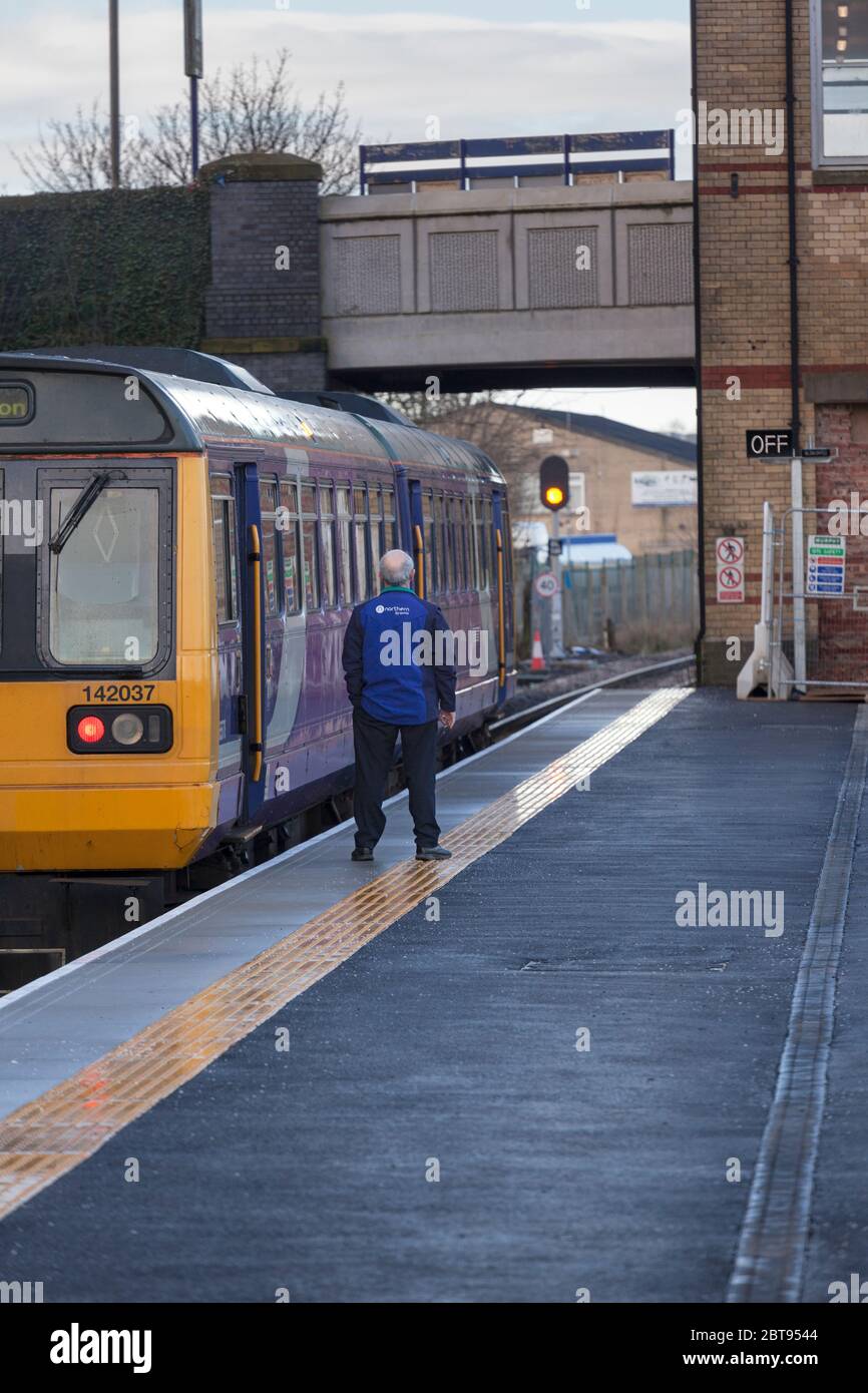 Guard conductor of a Northern rail class 142 pacer train waiting time at Kirkham and Wesham railway station before departure time Stock Photo