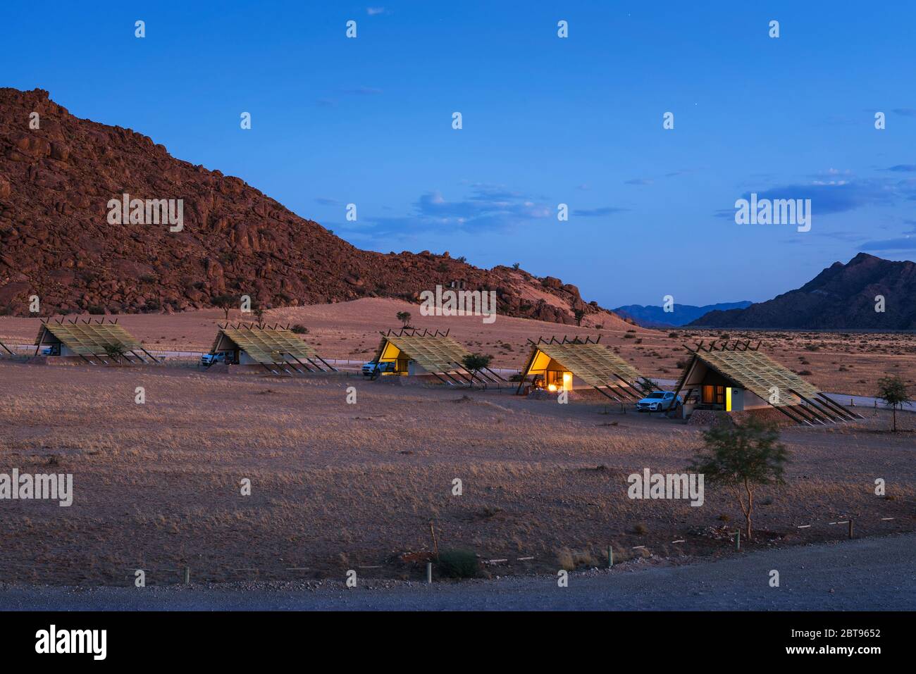 Evening at small chalets of a desert lodge near Sossusvlei in Namibia Stock Photo
