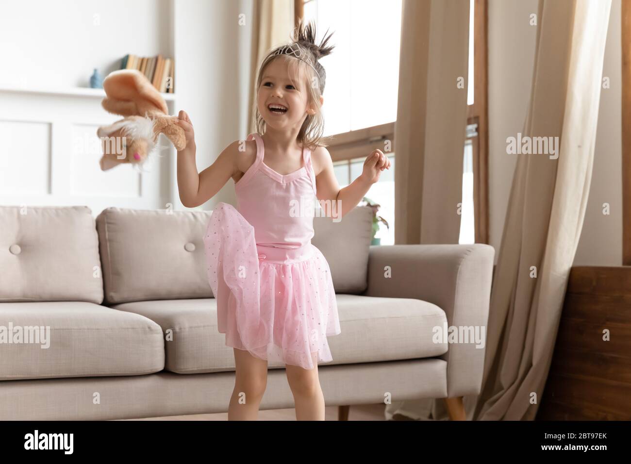 Portrait laughing cute little girl wearing princess dress and diadem Stock Photo