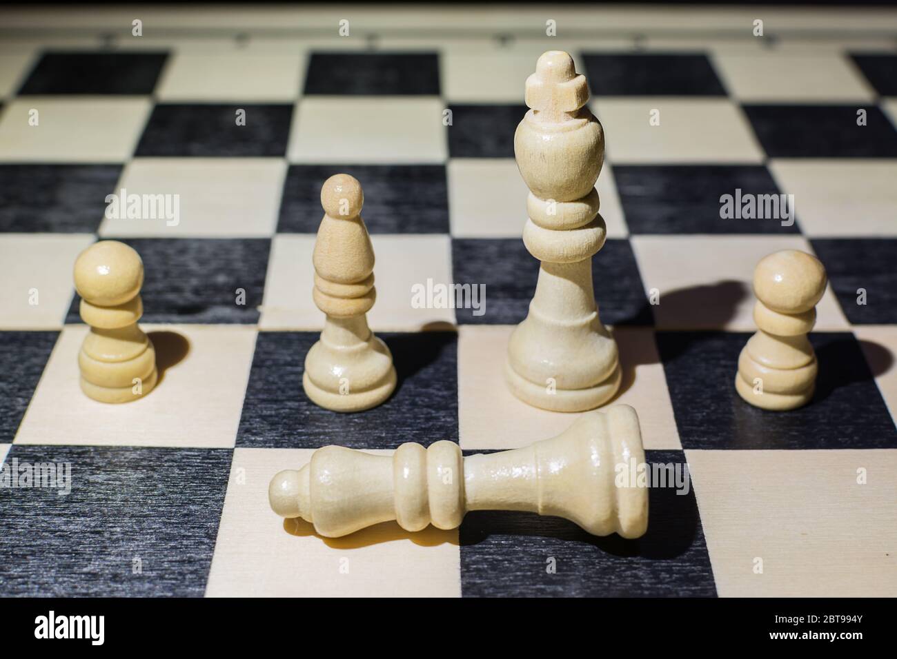 Woman Hand Holding a White Queen Piece Over a Chess Board