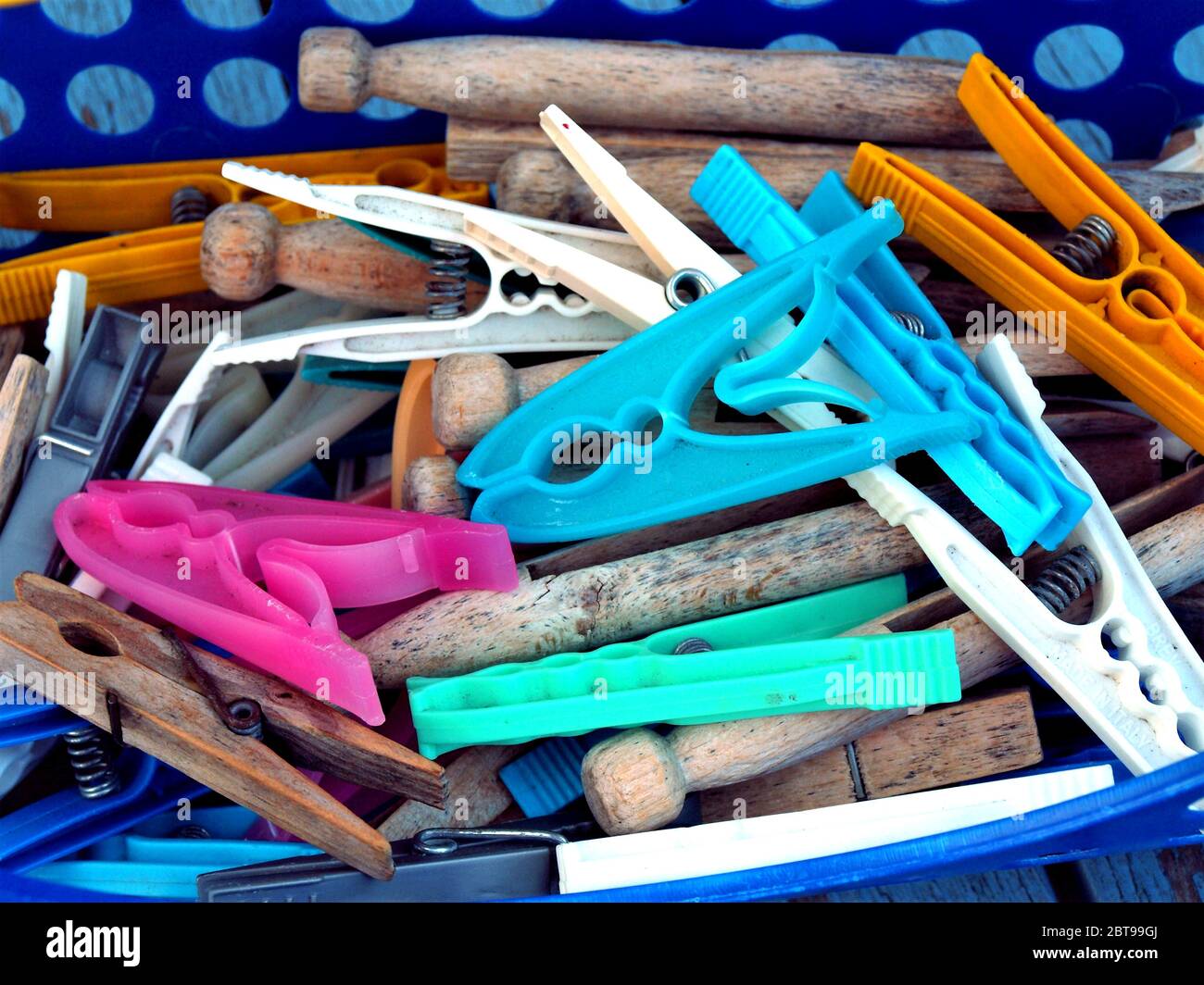 Sutton in Ashfield, Nottinghamshire, UK. July 23, 2010. Variety of plastic and wooden clothes pegs in the peg basket ready to peg washing to dry at Su Stock Photo