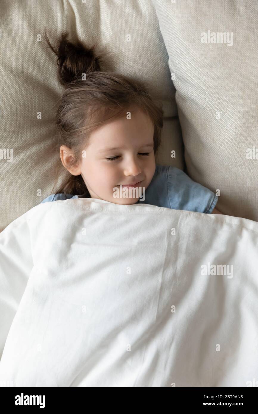 Top view cute peaceful little girl sleeping in cozy bed Stock Photo Alamy