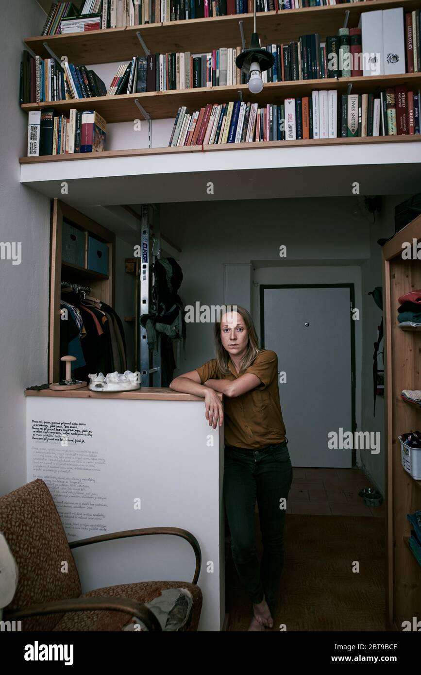 Environmental portrait of a female artist in her basement apartment in Prague Stock Photo
