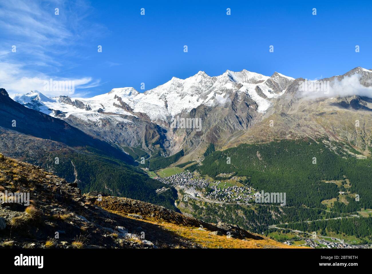 Mountain panorama with ski resort Saas Fee in valley. Stock Photo