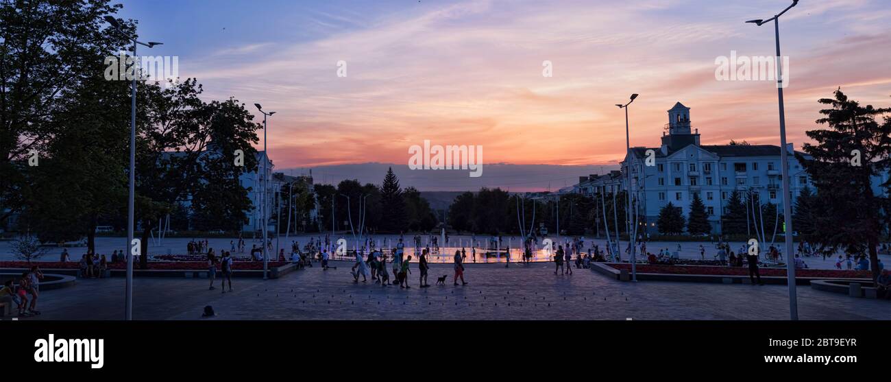 KRAMATORSK, UKRAINE - JUNE 18. 2019: The fountain with colour lights on the main square of Kramatorsk in the summer evening - entertainment not only f Stock Photo