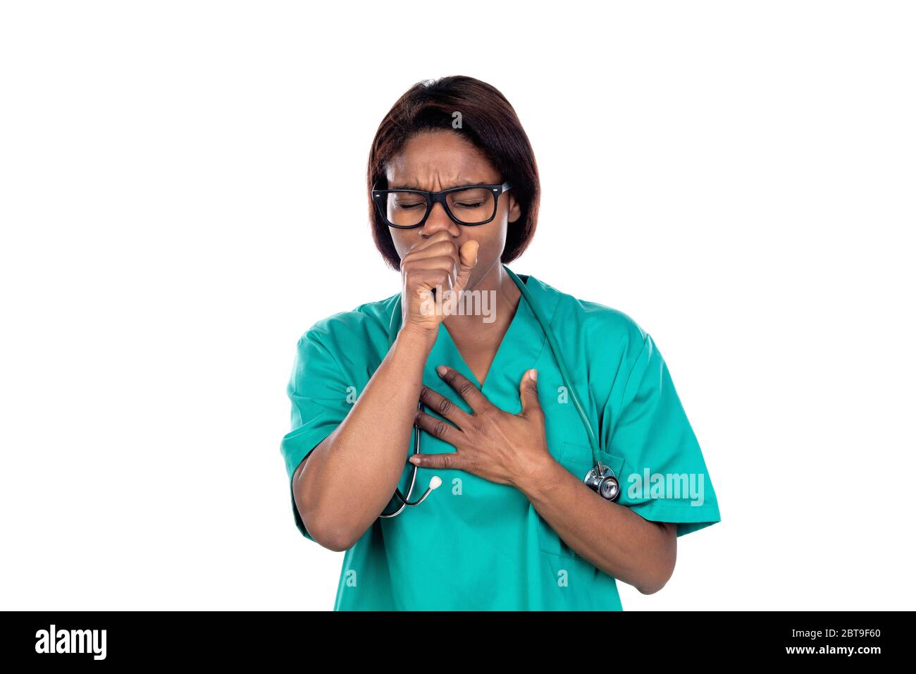 Doctor with green uniform coughing isolated on a white background Stock Photo