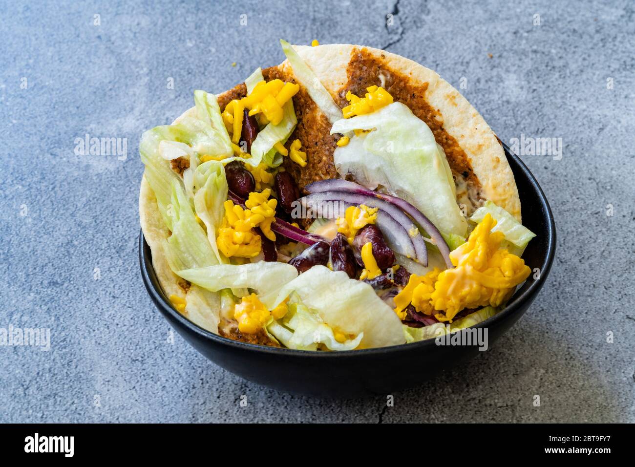Turkish Mexican Style Taco Cig Kofte with Kidney Beans, Red Onions, Grated Cheddar Cheese and Pomegranate Syrup Sauce. Traditional Fast Food. Stock Photo
