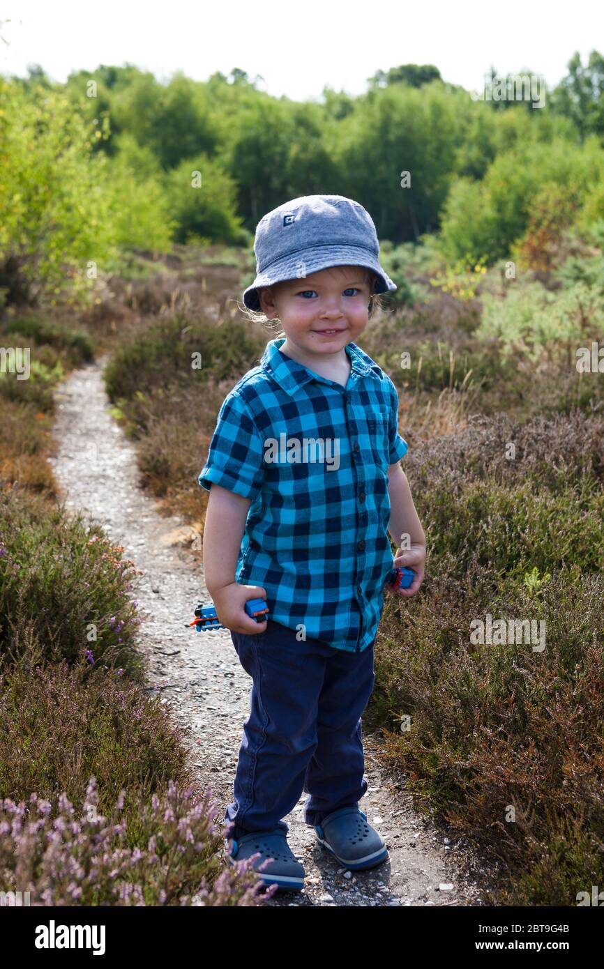 Happy, adorable little boy, 1 - 2 years old, out for a walk in Alver Valley Country Park, Gosport, Hampshire, England, UK. MODEL RELEASED Stock Photo