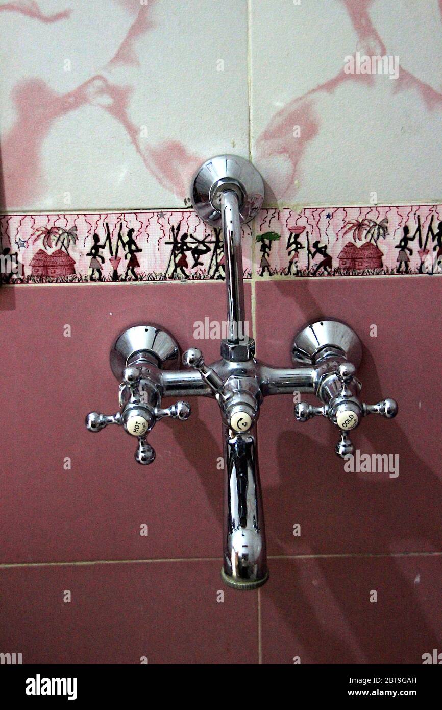 Hot and cold water mixing knobs fitted on wall in a luxury bathroom Stock Photo Alamy