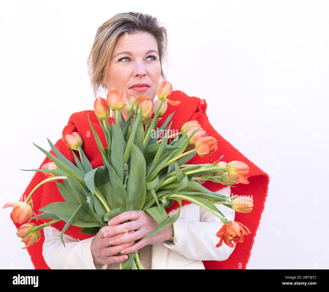 dutch flowers tulips beautiful woman behind flowers Stock Photo