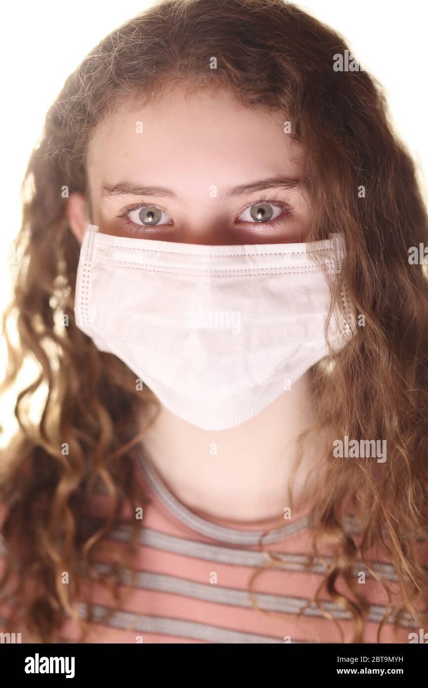 girl teenager in a mask on a white background Stock Photo