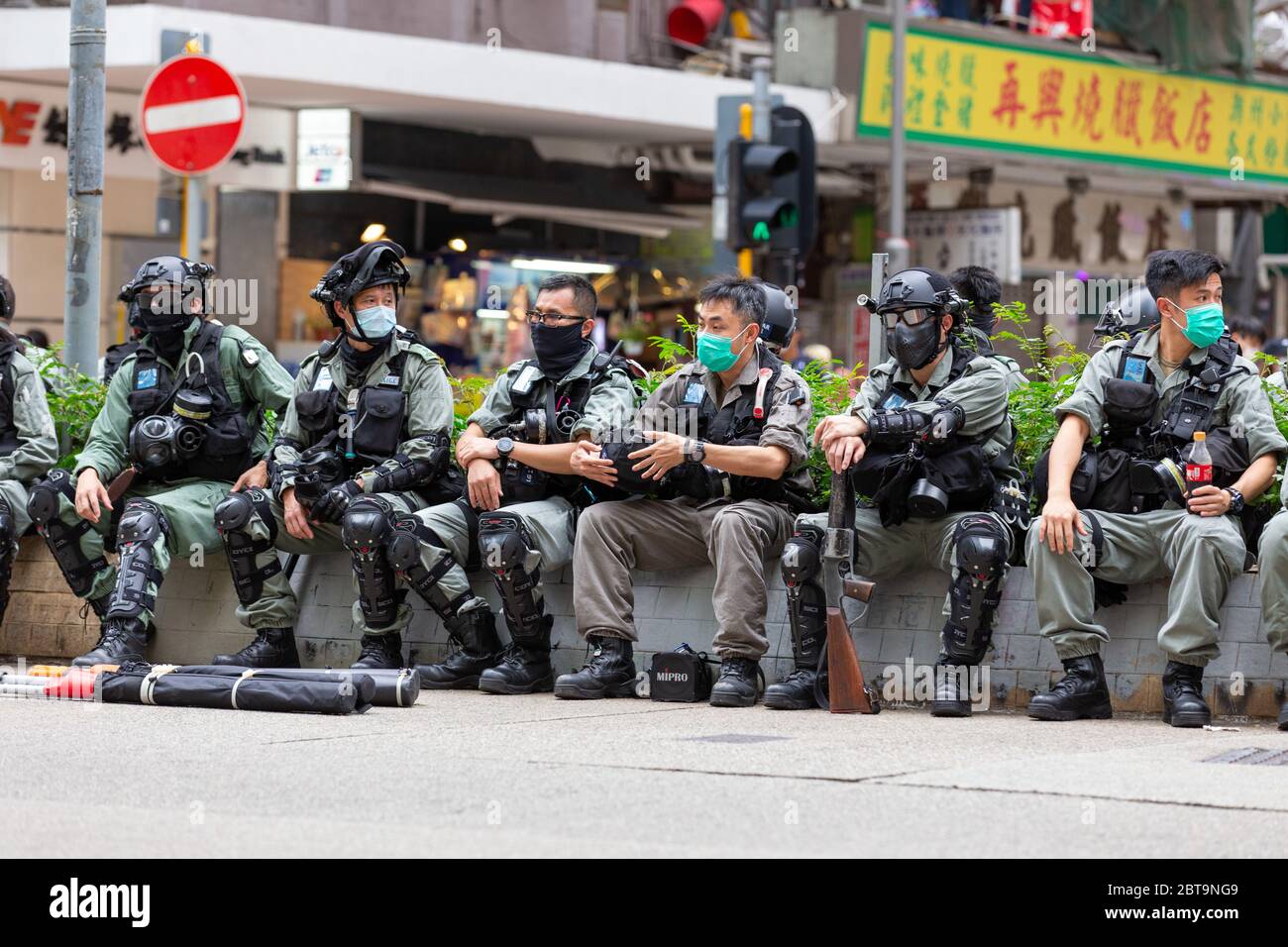 Hong Kong, 24th May 2020. Police resting roadside in Wanchai. Credit: David Ogg / Alamy Live News Stock Photo