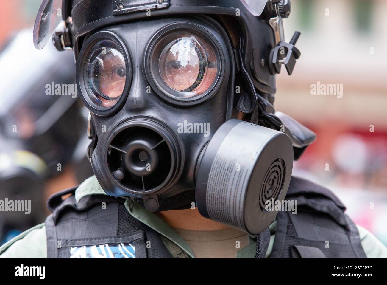Hong Kong, 24th May 2020. HK Police officer in gas mask.Credit: David Ogg / Alamy Live News Stock Photo
