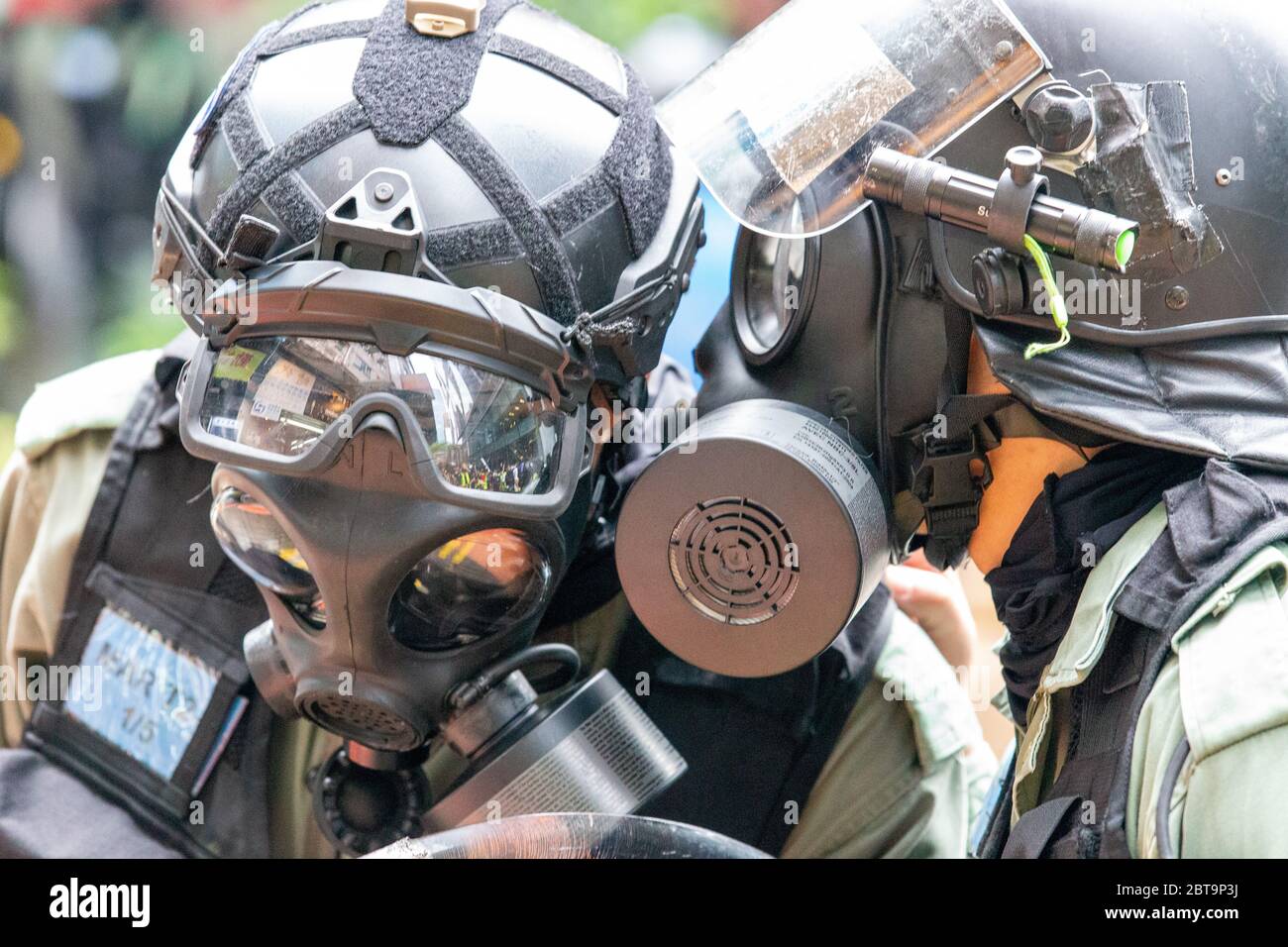 Hong Kong, 24th May 2020. HK Police officers talking through gas masks..Credit: David Ogg / Alamy Live News Stock Photo