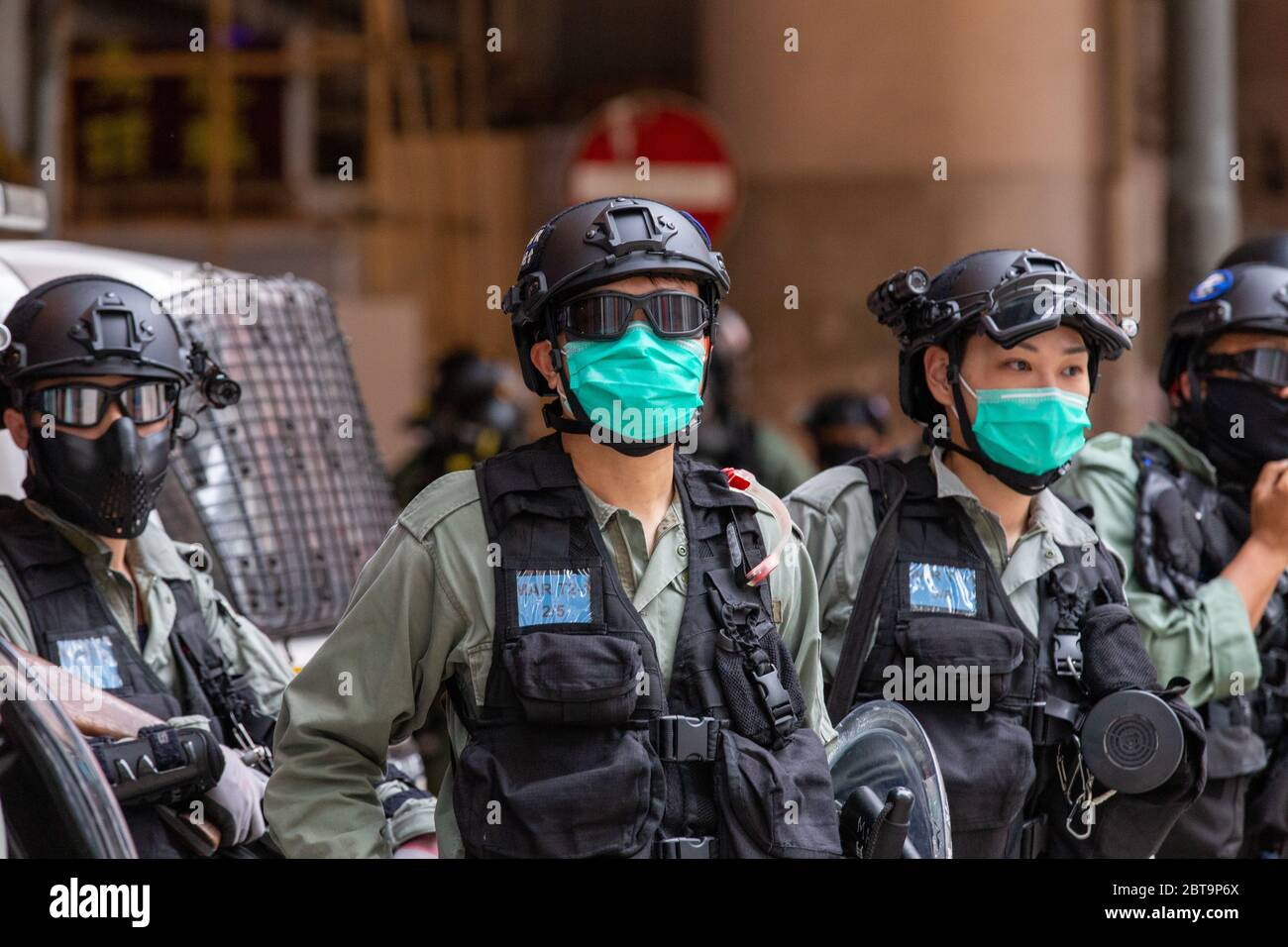 Hong Kong, 24th May 2020. HK Police officers stand watch at road side. Credit: David Ogg / Alamy Live News Stock Photo