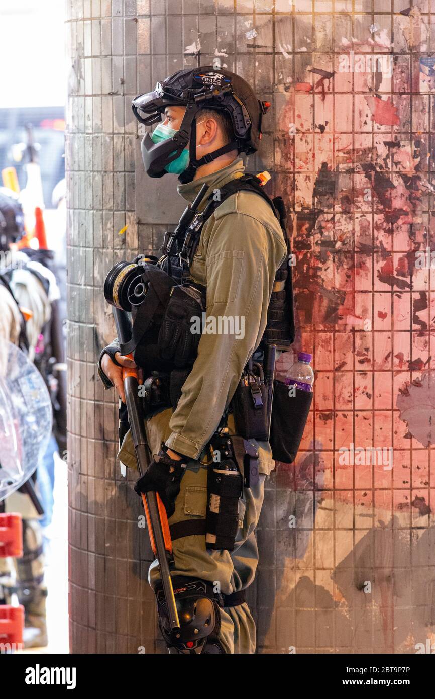 Hong Kong, 24th May 2020. Hk Police officer watching the crowd. Credit: David Ogg / Alamy Live News Stock Photo