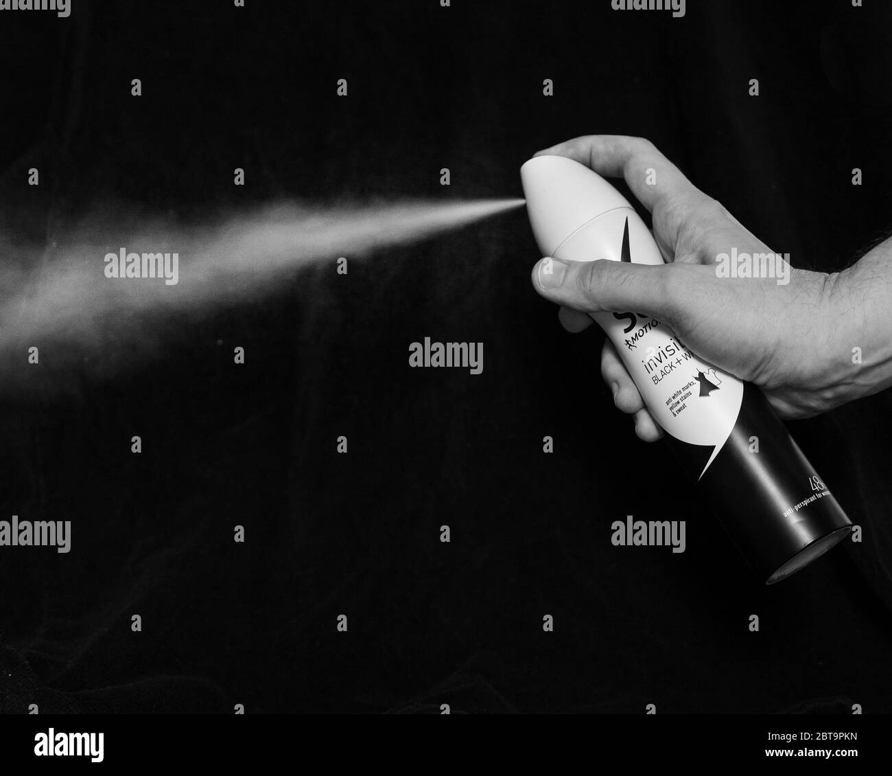 Close up of a hand spraying deodorant Stock Photo Alamy