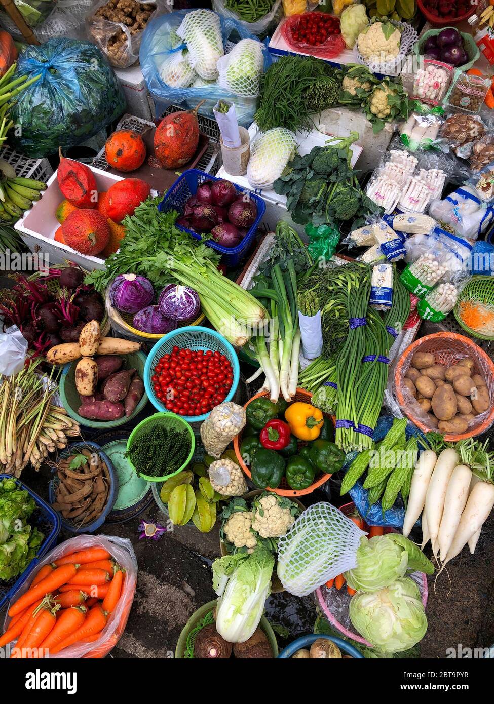 Top view on a large assortment of row loose vegetables and fruits for sale in a street. Short circuit production Stock Photo