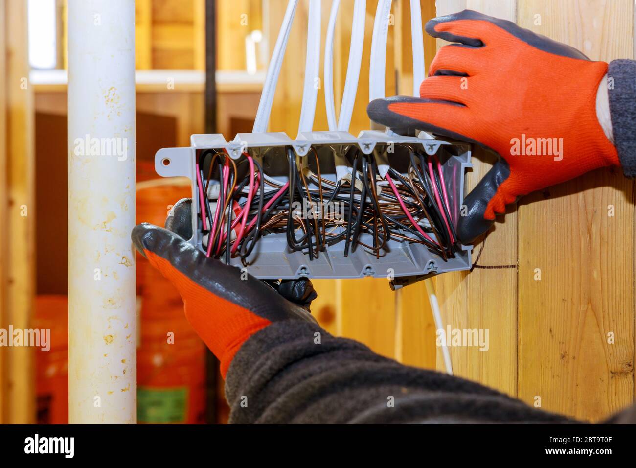 Electrical socket boxes inside a wooden beams frame house with basic electrical wiring Stock