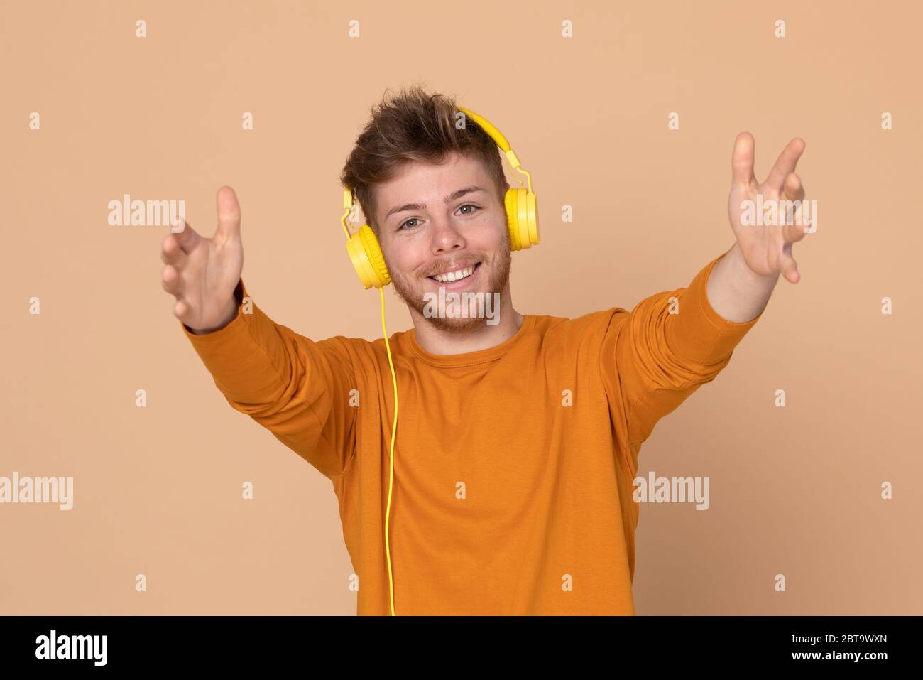 Attractive young guy on a yellow background Stock Photo