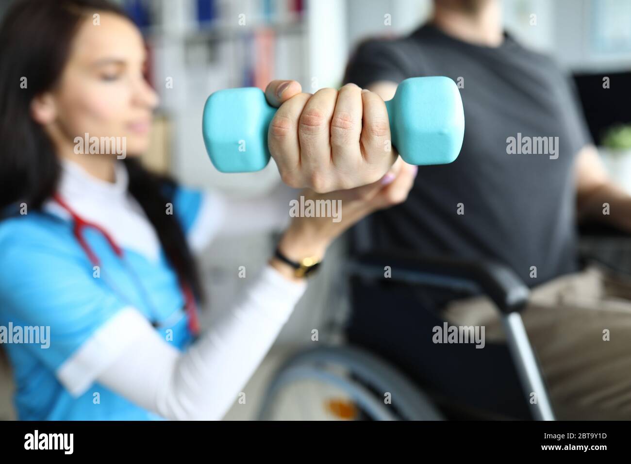 Man on stroller doing exercises with dumbbells Stock Photo